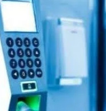 Keypad and fingerprint access control reader beside a door
